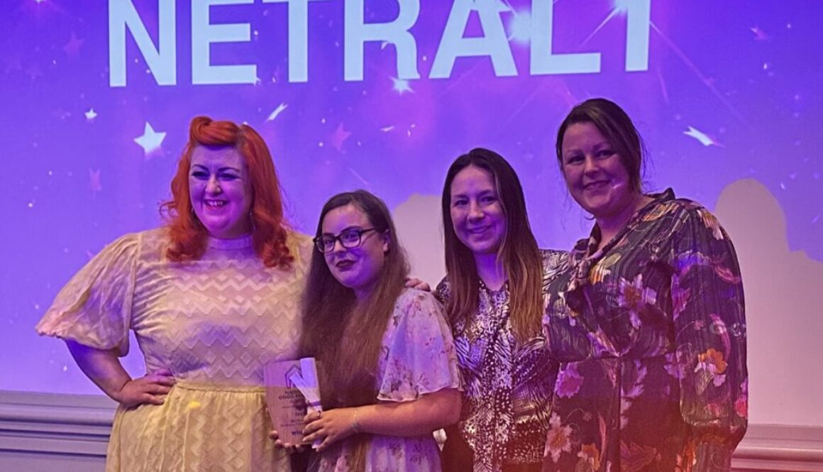 photo of NETRALT collecting award from Michelle McManus